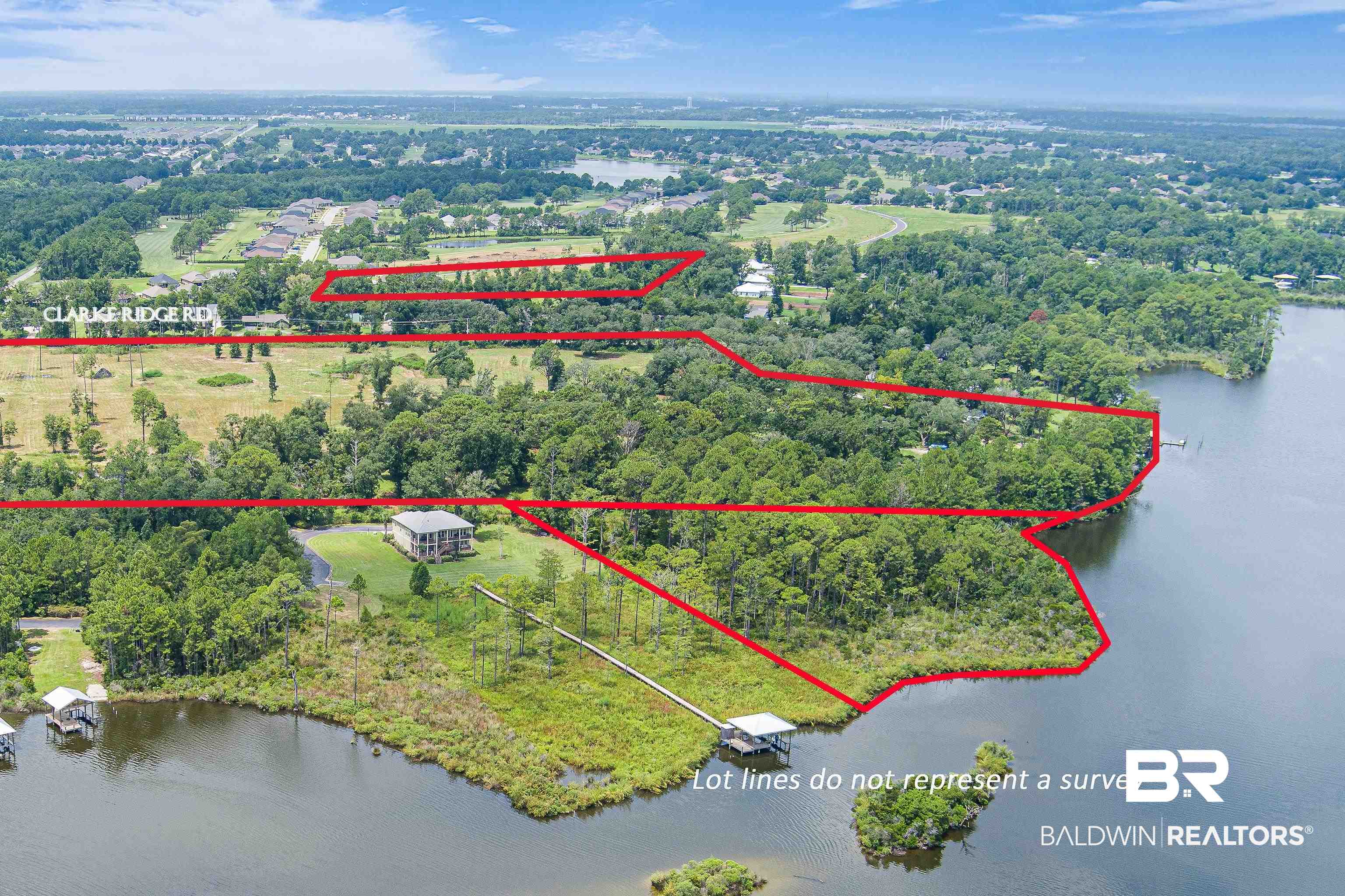 9124 Clarke Ridge Road Foley, AL 36535 - Photo 1 of 8 Aerial view of property and surrounding area featuring a large body of water and property boundaries highlighted