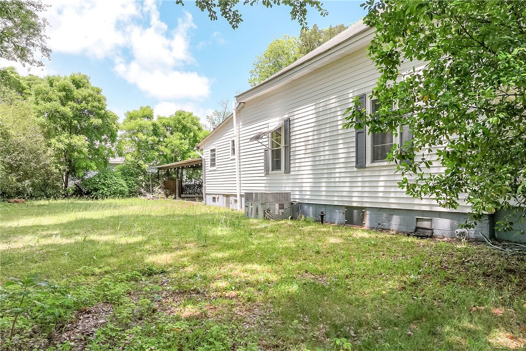 59 Church Street Notasulga, AL 36866 - Photo 9 of 38 This property features a spacious yard and classic siding, creating an inviting outdoor atmosphere.