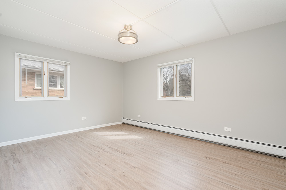 21 South Waiola Avenue, Unit 7 La Grange, IL 60525 - Photo 12 of 18 an empty room with wooden floor and windows