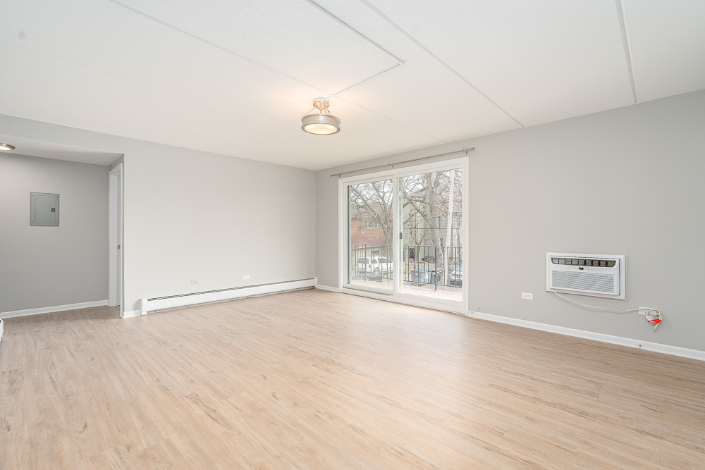 21 South Waiola Avenue, Unit 7 La Grange, IL 60525 - Photo 15 of 18 a view of an empty room with wooden floor and a window