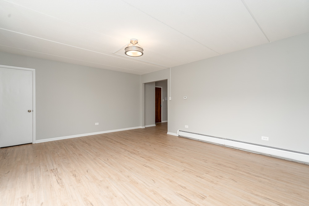 21 South Waiola Avenue, Unit 7 La Grange, IL 60525 - Photo 16 of 18 an empty room with wooden floor and windows
