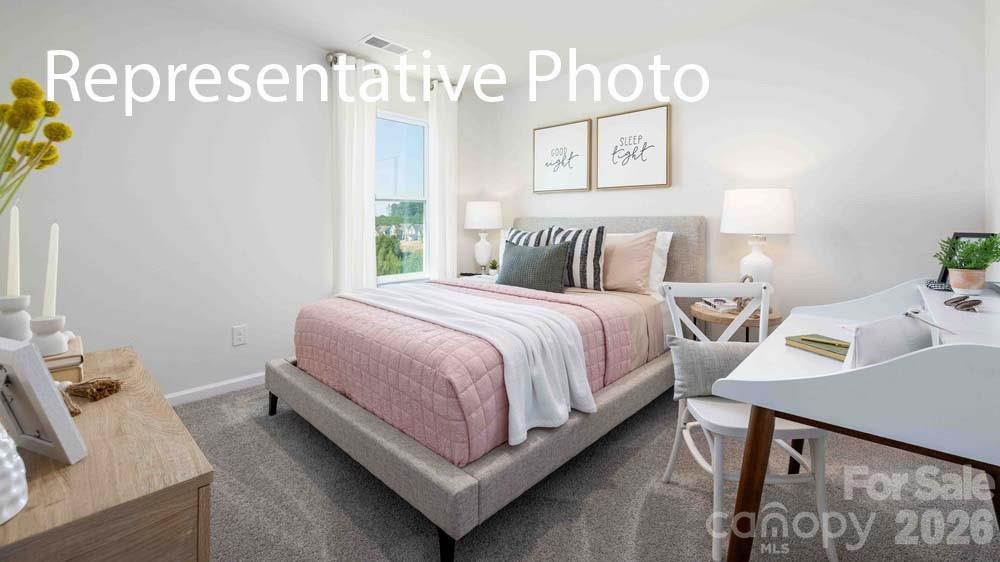7592 Bainbridge Road Sherrills Ford, NC 28673 - Photo 20 of 28 a bedroom with a bed and window
