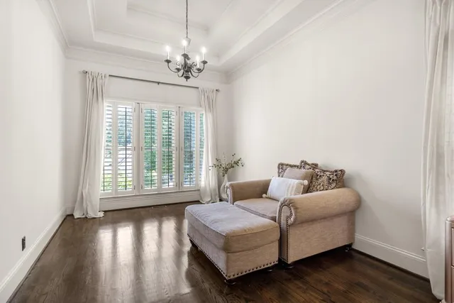 a spacious bedroom with a bed and a dresser