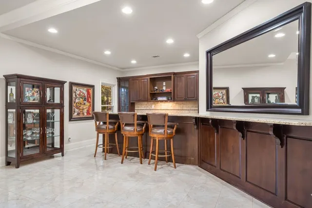 a view of a backyard with table and chairs and potted plants