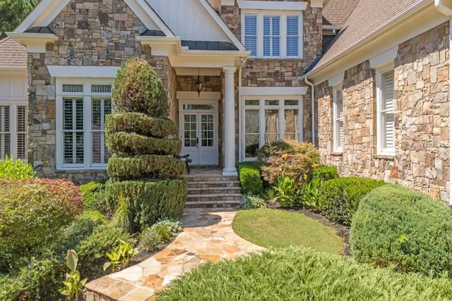 a view of a house with potted plants