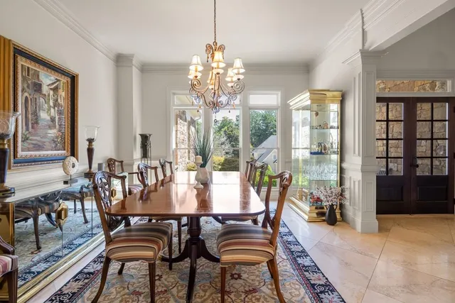 a dining room with furniture a chandelier and wooden floor