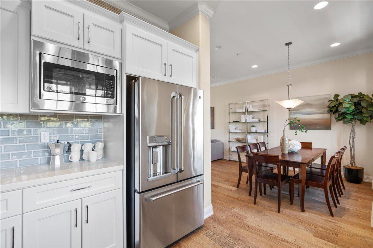 725 Reflection Way Mountain View, CA 94043 - Photo 19 of 39 a kitchen with stainless steel appliances kitchen island granite countertop a refrigerator a stove a dining table and chairs