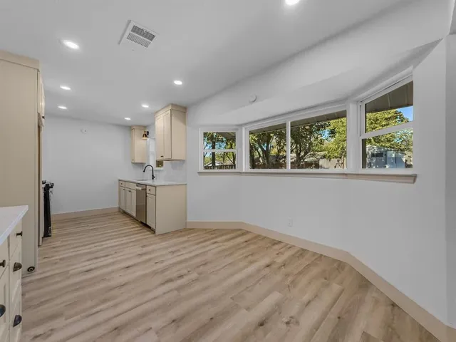 a view of kitchen with wooden floor and window