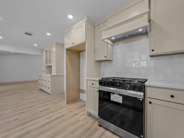 a kitchen with stainless steel appliances granite countertop a stove and a refrigerator