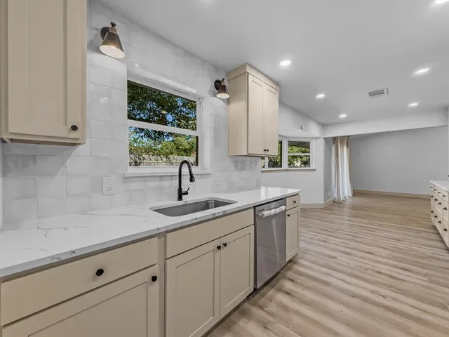 a kitchen with a sink and cabinets