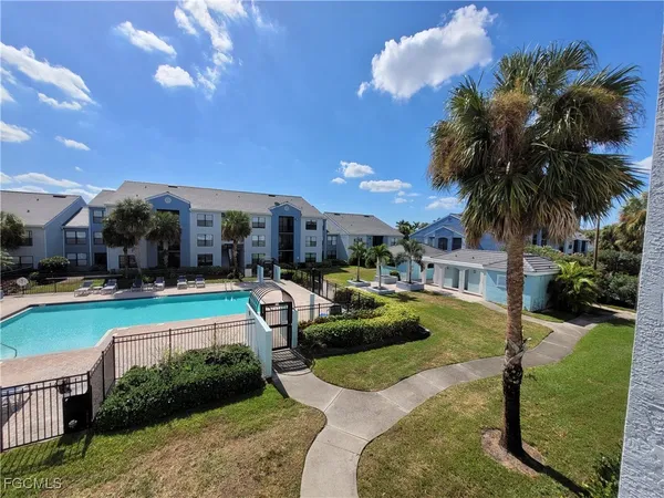 a view of a swimming pool and lounge chairs