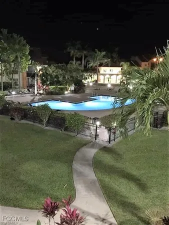 a view of a swimming pool with a yard