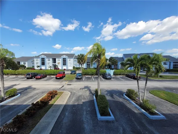 a view of a bathroom with a sink and a painting on the wall
