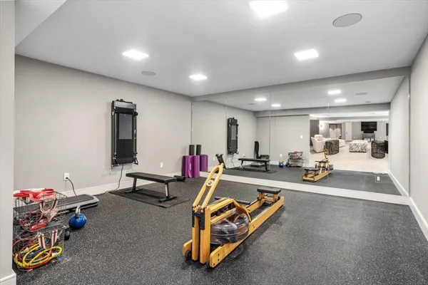 a living room with furniture gym equipment and a table