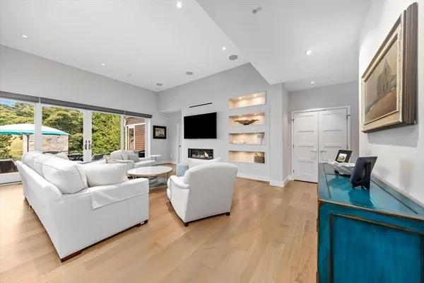 a living room with fireplace furniture and a flat screen tv