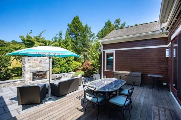a backyard of a house with wooden floor yard fire pit and chairs