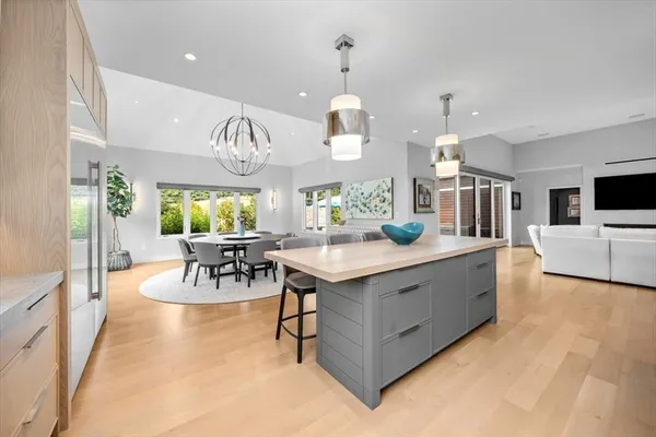 a living room with furniture a chandelier and a flat screen tv