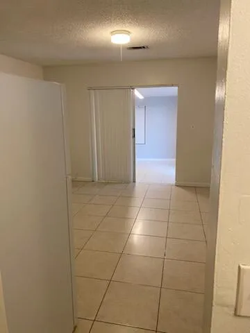 a view of hallway with a bathroom