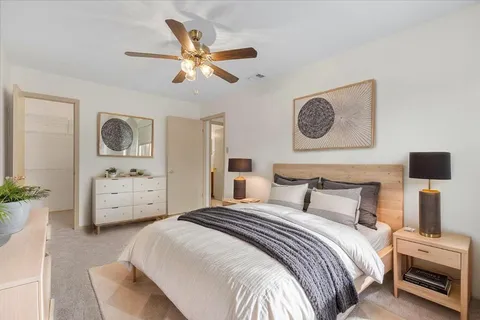 a bedroom with a bed and a television