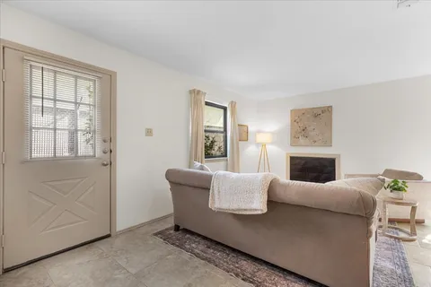 a living room with furniture a fireplace and a window