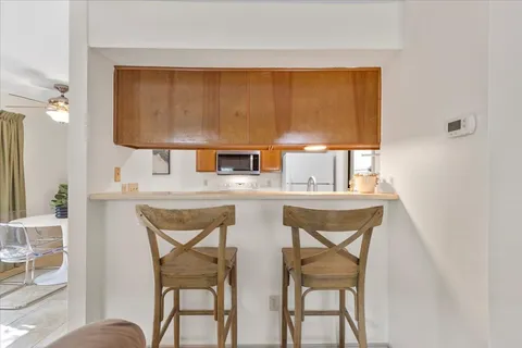a view of a dining room with furniture and window