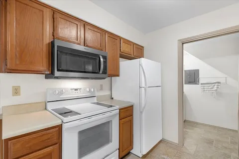 a kitchen with stainless steel appliances a refrigerator stove and microwave