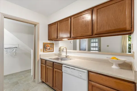 a kitchen with stainless steel appliances granite countertop a sink and cabinets
