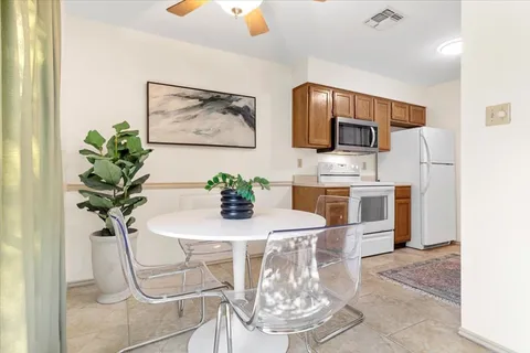 a dining room with furniture and chandelier