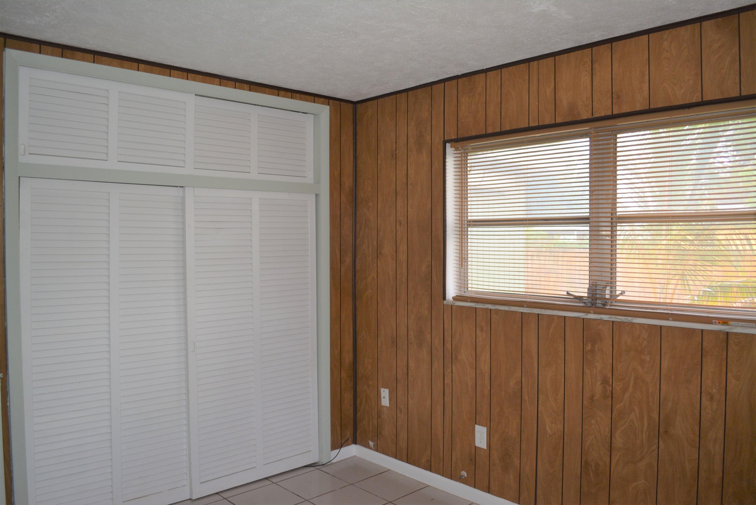 28520 Southwest 146th Avenue Homestead, FL 33033 - Photo 14 of 23 a view of an empty room with wooden floor and a window