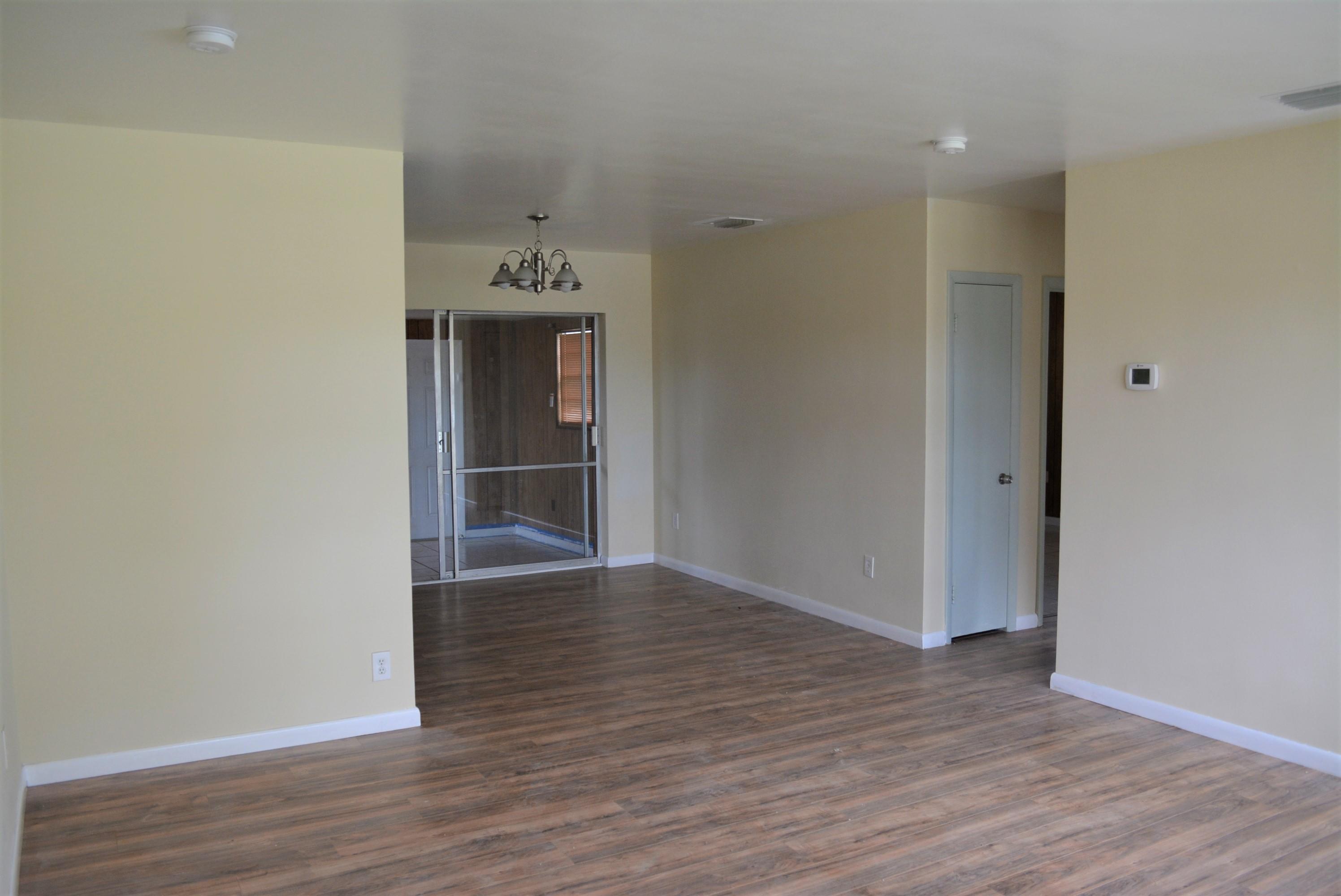 28520 Southwest 146th Avenue Homestead, FL 33033 - Photo 4 of 23 a view of an empty room with wooden floor and a window