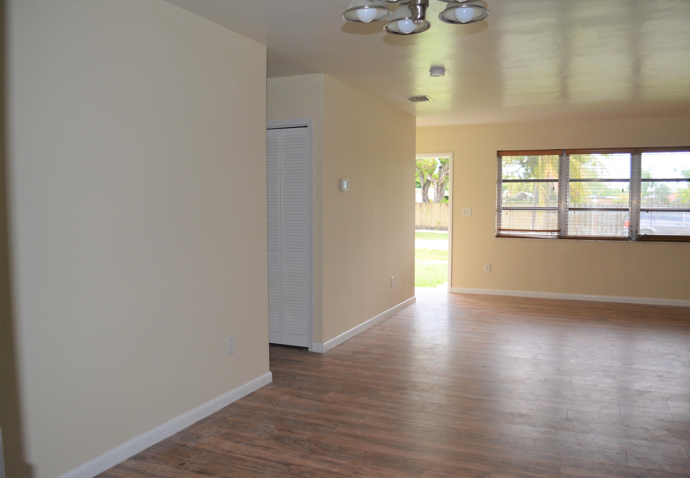 28520 Southwest 146th Avenue Homestead, FL 33033 - Photo 5 of 23 a view of an empty room with wooden floor and a window
