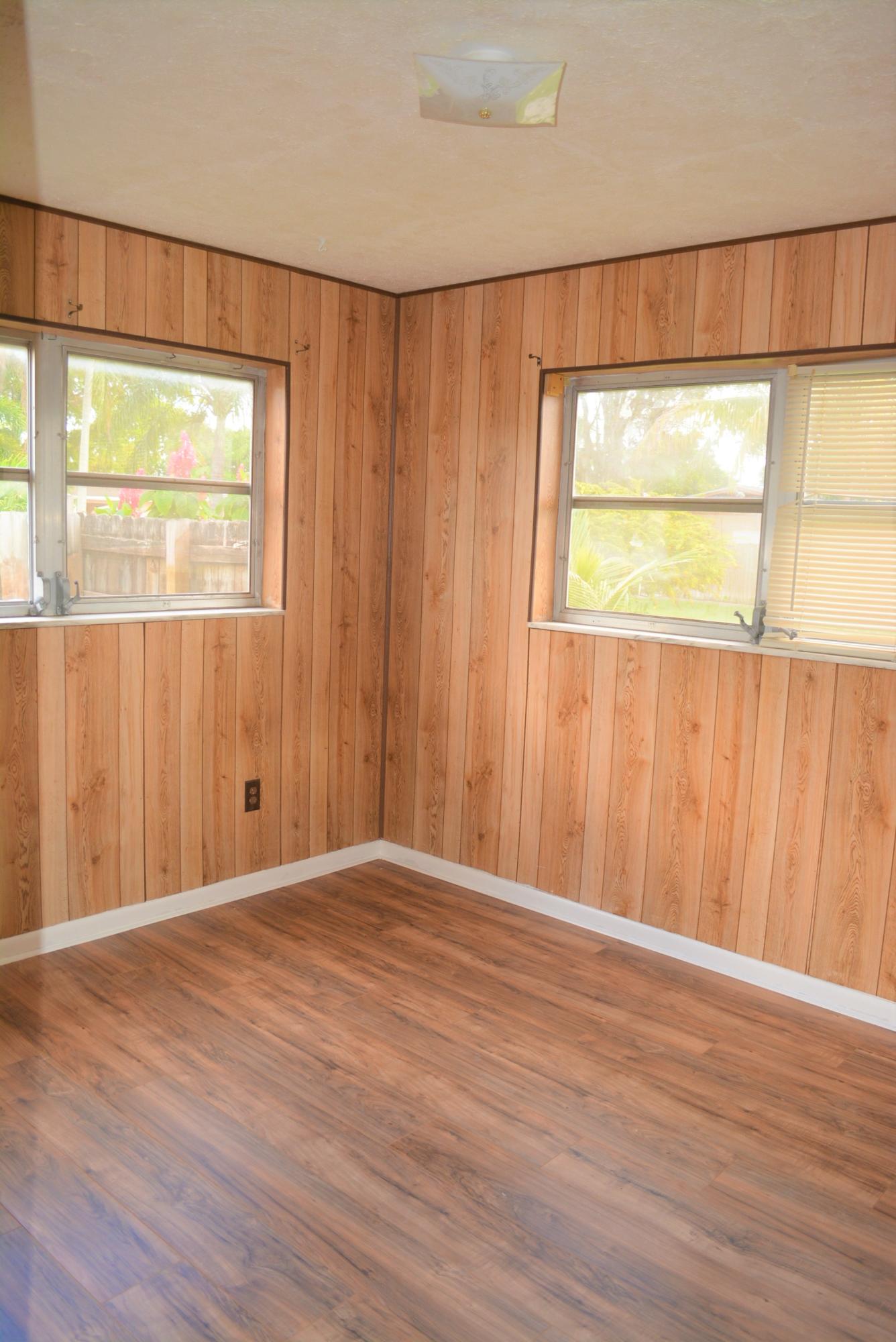 28520 Southwest 146th Avenue Homestead, FL 33033 - Photo 9 of 23 an empty room with wooden floor and a window