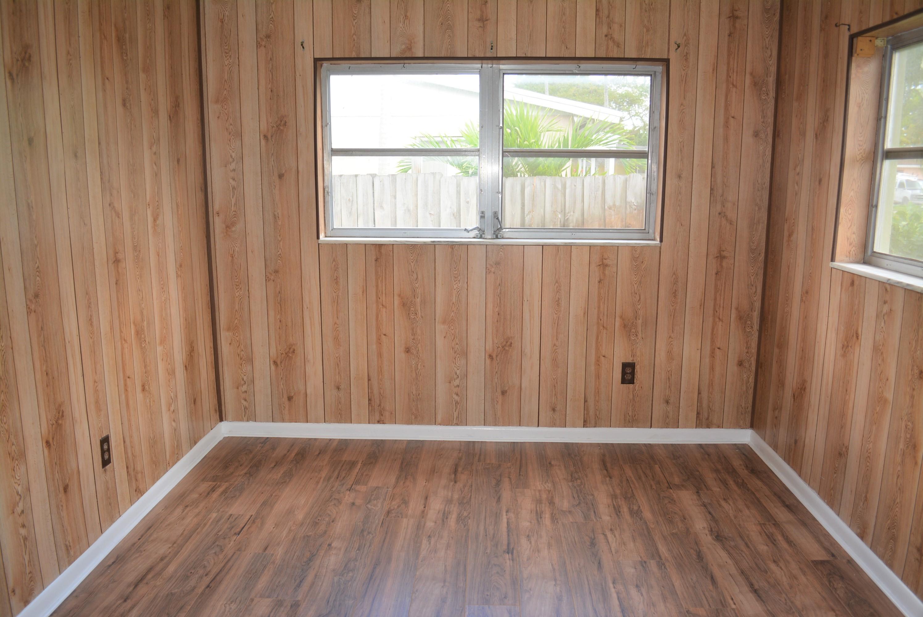 28520 Southwest 146th Avenue Homestead, FL 33033 - Photo 10 of 23 a view of an empty room with wooden floor and a window