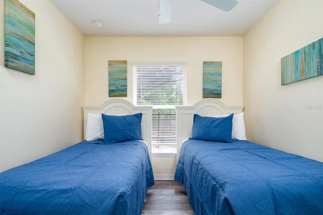 a bedroom with two beds and a large window