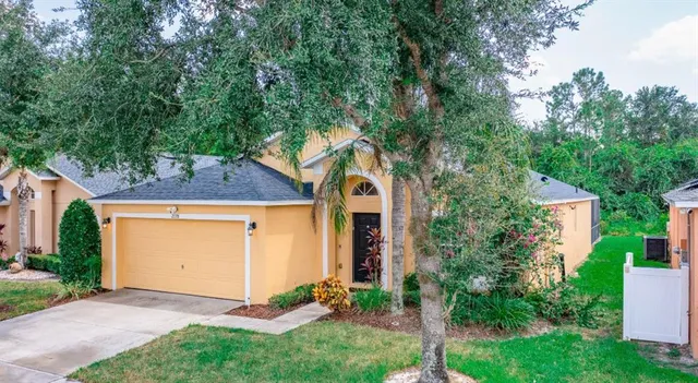a front view of house with green space