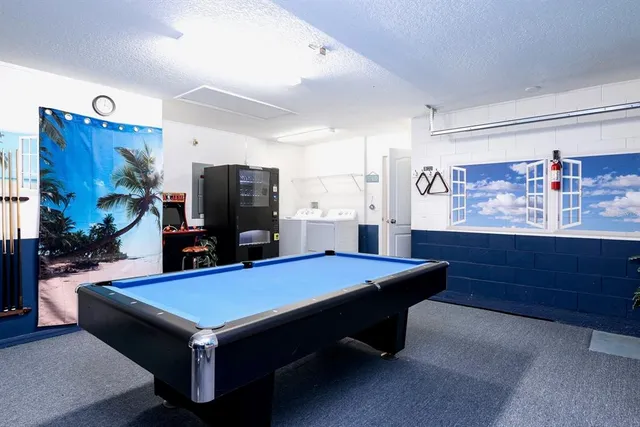a room with pool table and flat screen tv