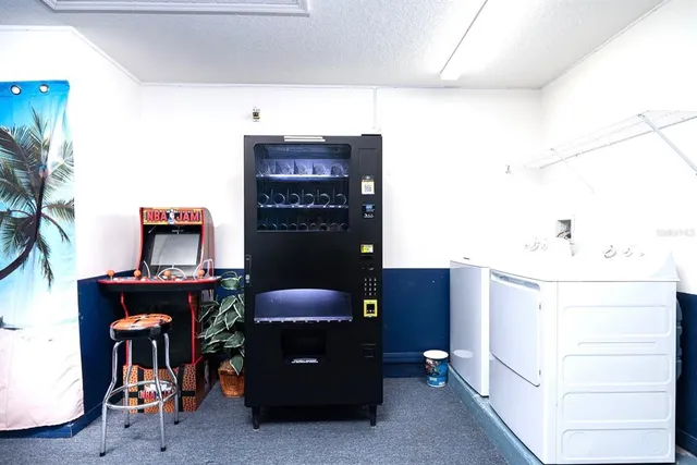 a room with furniture pool table and potted plants