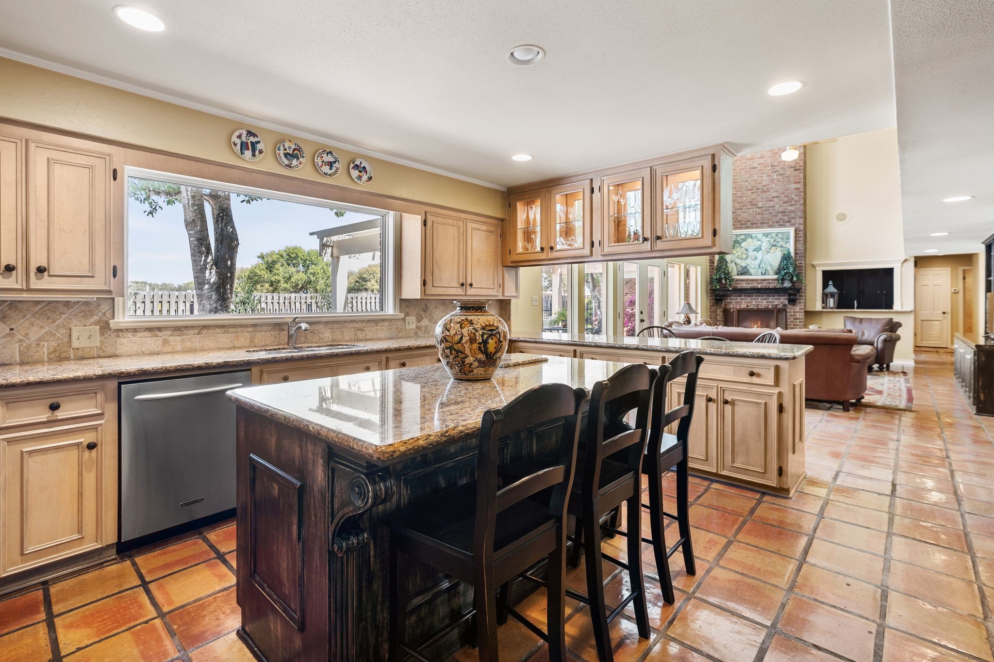 905 Sunny Lane Wharton, TX 77488 - Photo 15 of 50 a kitchen with stainless steel appliances granite countertop a stove a refrigerator a sink dishwasher a dining table and chairs with wooden floor