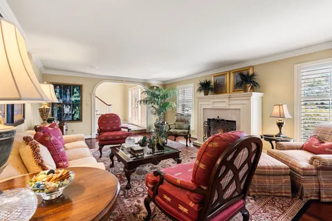 a kitchen with stainless steel appliances granite countertop a stove a refrigerator a sink dishwasher a dining table and chairs with wooden floor