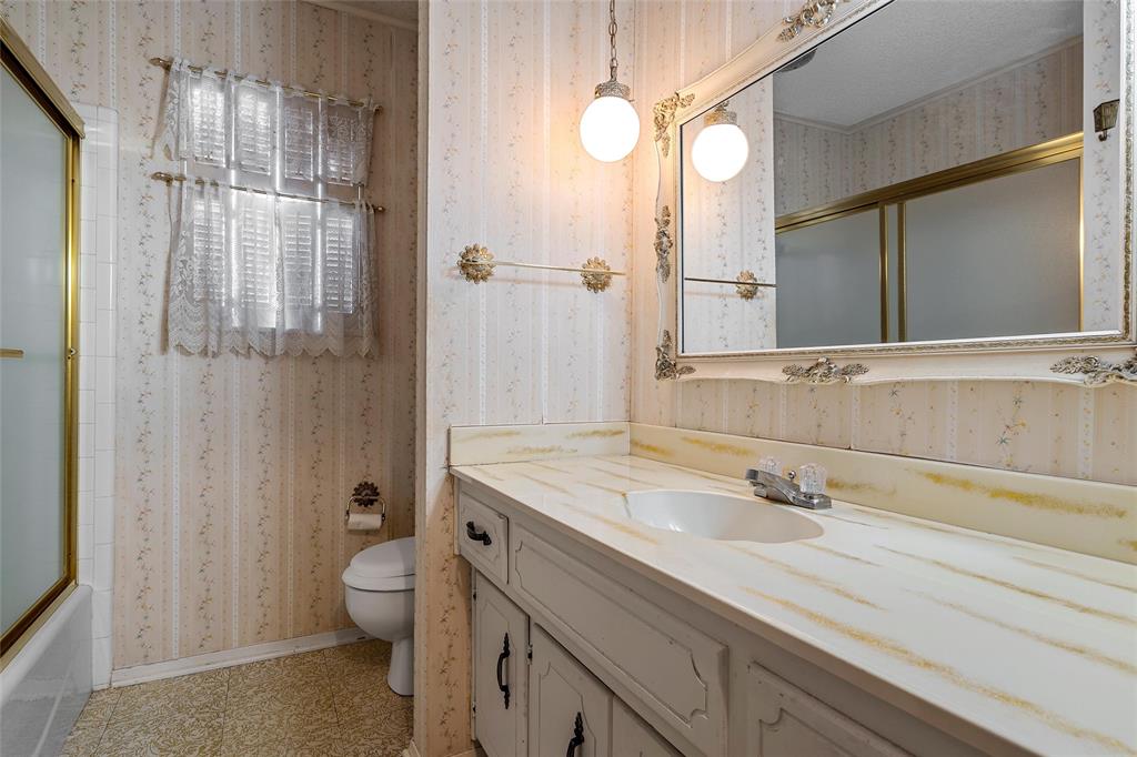 219 Opal Street Hewitt, TX 76643 - Photo 14 of 28 a bathroom with a sink a toilet and shower