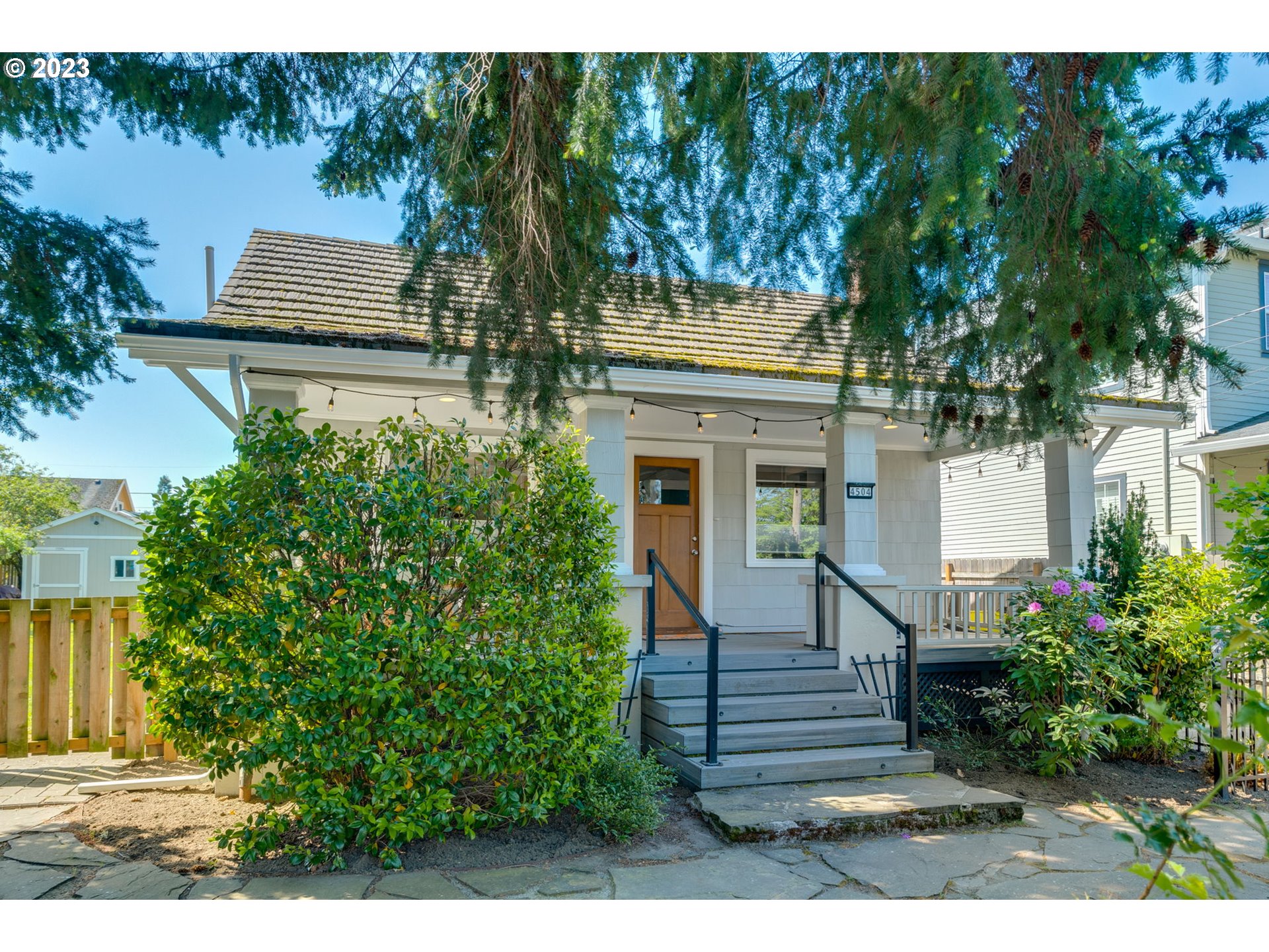 4504 Northeast Alberta Court Portland, OR 97218 - Photo 1 of 37 a front view of a house with a garden