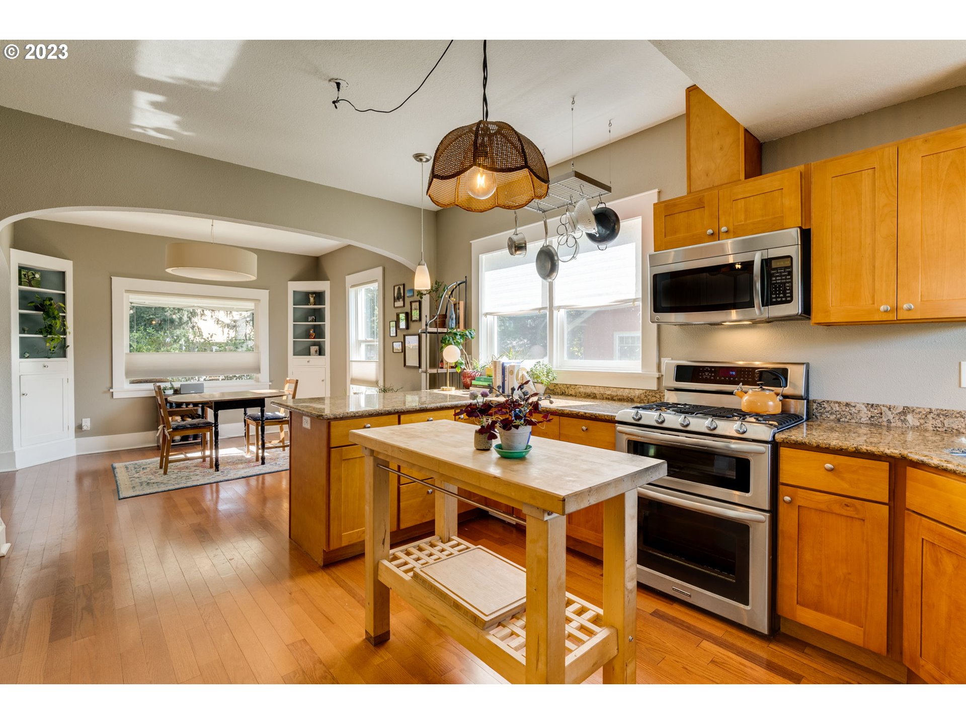 4504 Northeast Alberta Court Portland, OR 97218 - Photo 11 of 37 a kitchen with stainless steel appliances a stove a sink and a refrigerator
