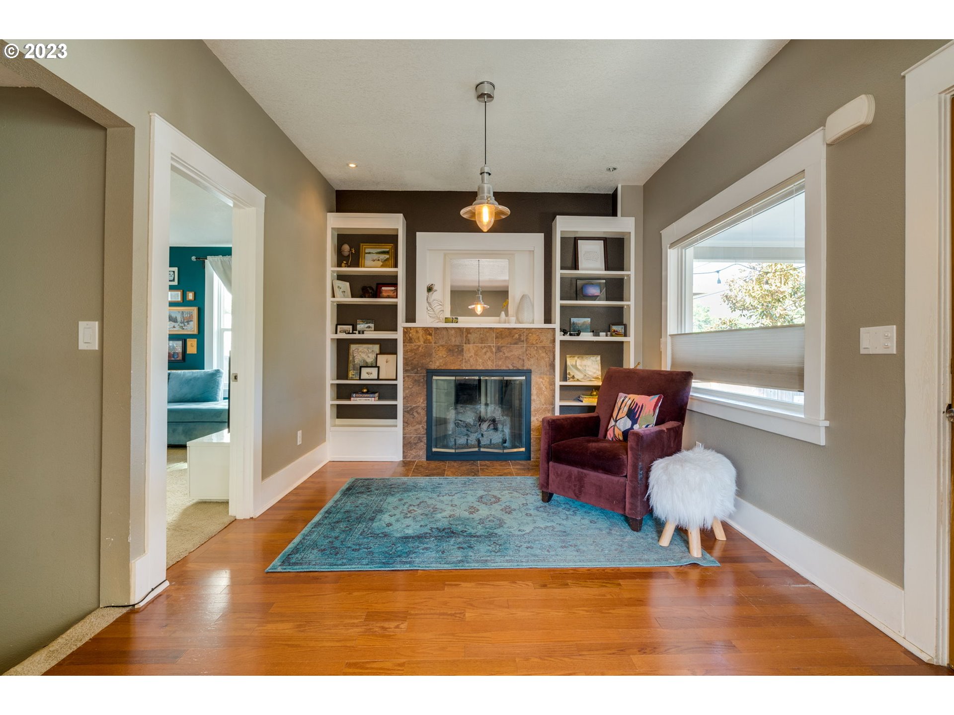 4504 Northeast Alberta Court Portland, OR 97218 - Photo 14 of 37 a living room with furniture a window and a fireplace