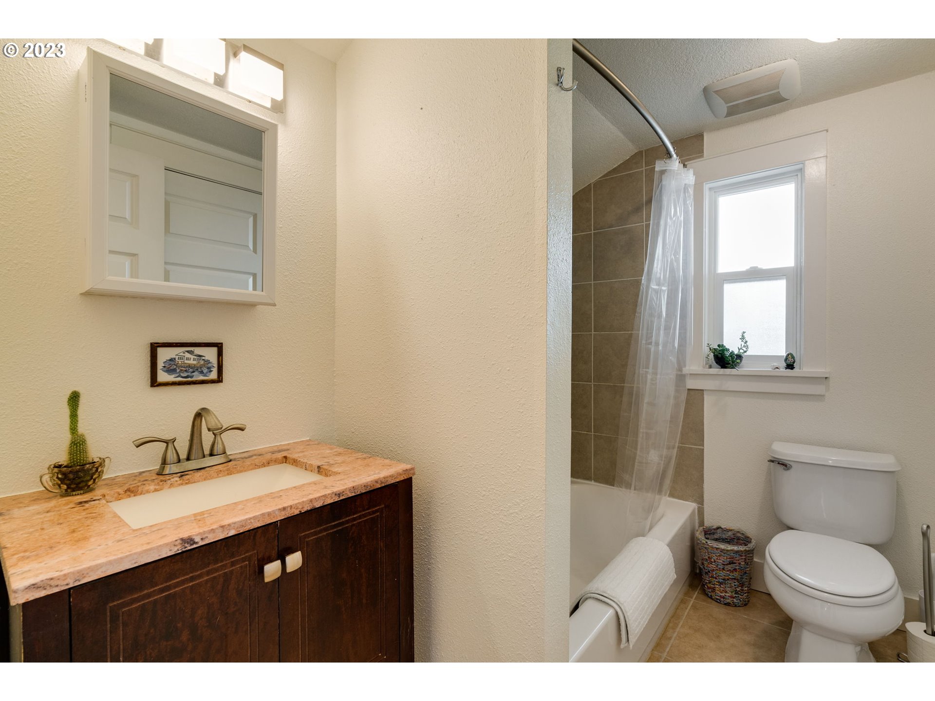 4504 Northeast Alberta Court Portland, OR 97218 - Photo 17 of 37 a bathroom with a granite countertop toilet sink and mirror
