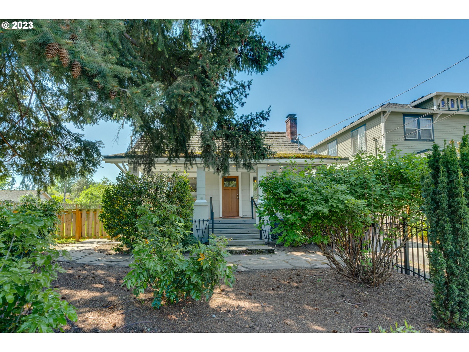 4504 Northeast Alberta Court Portland, OR 97218 - Photo 2 of 37 a view of a house with a tree