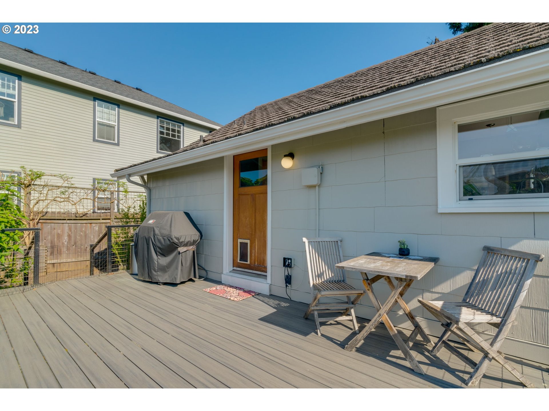 4504 Northeast Alberta Court Portland, OR 97218 - Photo 27 of 37 a roof deck with table and chairs and wooden floor