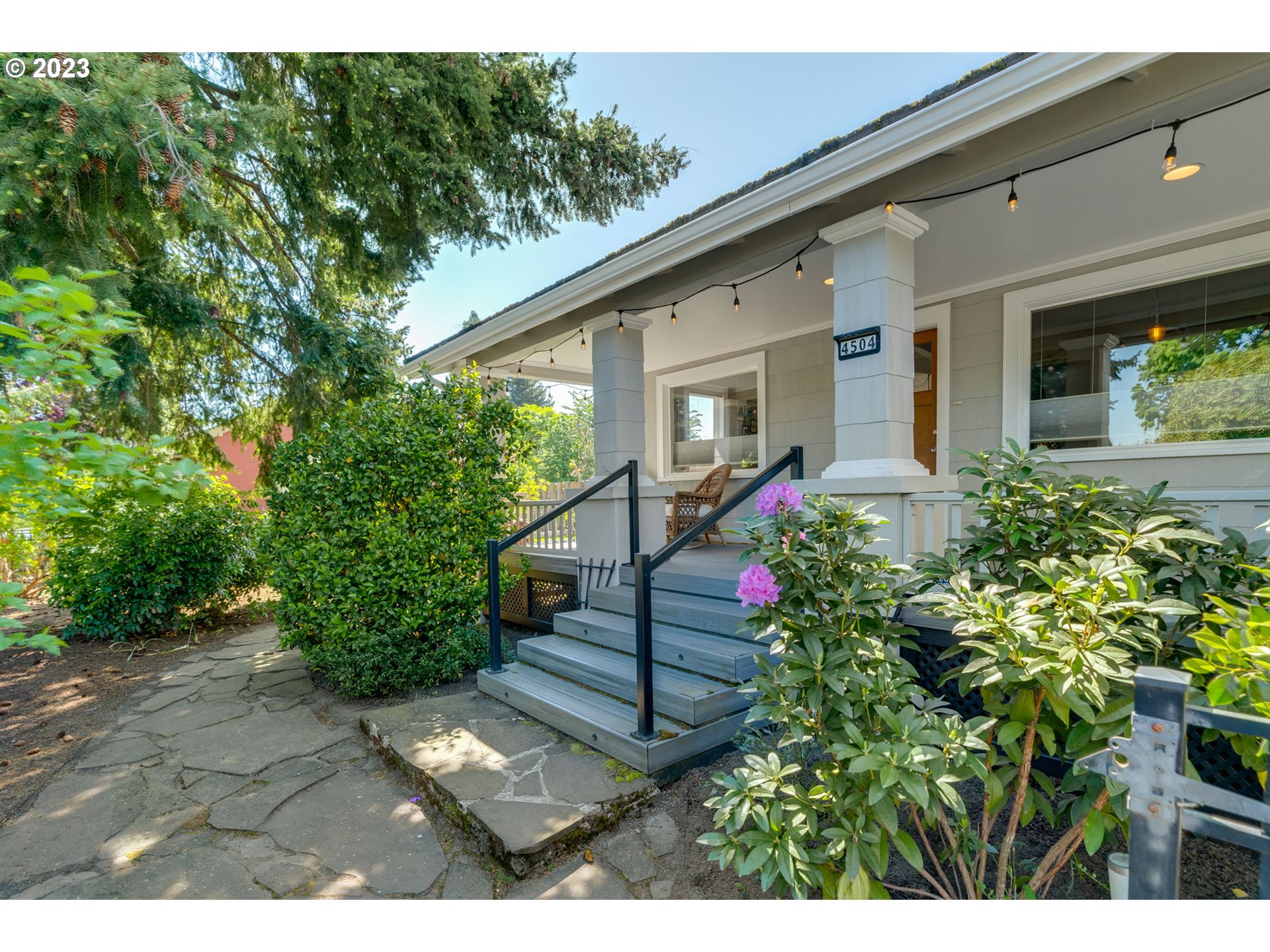 4504 Northeast Alberta Court Portland, OR 97218 - Photo 3 of 37 a view of a house with potted plants