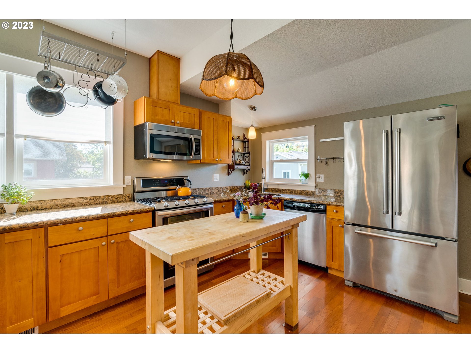 4504 Northeast Alberta Court Portland, OR 97218 - Photo 9 of 37 a kitchen with stainless steel appliances a stove a refrigerator and a sink