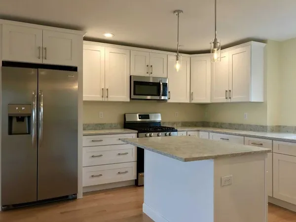 a kitchen with a refrigerator stove and microwave