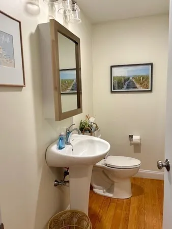 a bathroom with a sink toilet and mirror